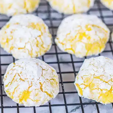 Luscious lemon cream cheese crinkle cookies perfectly baked until puffy and chilling before sharing.