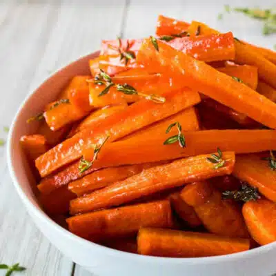 Square image of honey & herb roasted carrots.