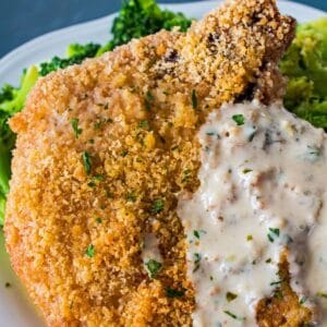 Delicious oven baked Parmesan crusted pork chops are a perfect family dinner that isn't complete without this super, tangy and fresh lemon basil sauce!