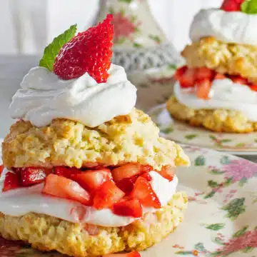 Best strawberry shortcake dessert recipe just like my Grandma made them with tender semi-sweet biscuits with a touch of citrus and layers of macerated strawberries and homemade whipped cream.