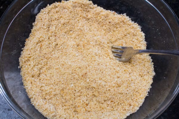butter coated Parmesan and breadcrumb mixture for the pork chops