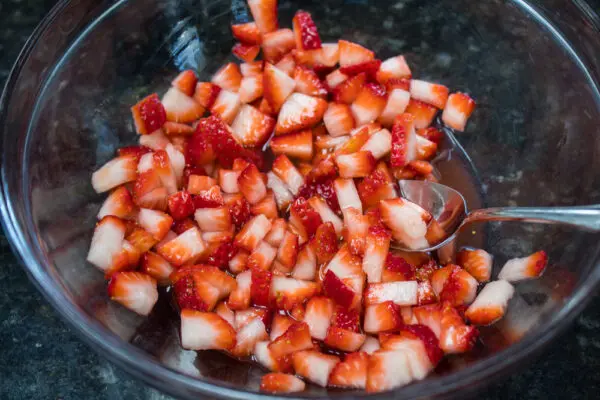 freshly sliced strawberries with lemon juice and sugar to make macerated strawberries