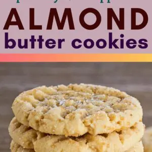pin image with top image showing an adolescent hand picking up one of the easy almond butter cookies from a cooling rack with a small glass of milk in the other hand and bottom image showing the cookies stacked eight cookies high with one tilted against the front of the stack on the left with medium brown wooden background