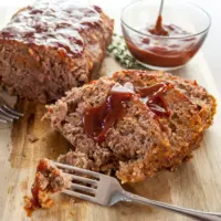 Boston Market meatloaf sliced on a cutting board.