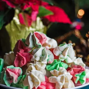 large square straight on image of the red green and white Christmas cake batter meringues.
