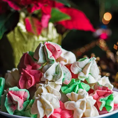 small square straight on image of the red green and white Christmas cake batter meringues.