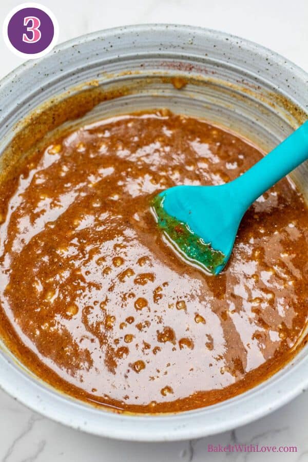 Brown sugar dijon pork roast process photo 3 showing the sugar and mustard glaze ingredients mixed together in a bowl with a silicone spatula.