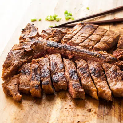 Pan seared porterhouse steak on a cutting board.