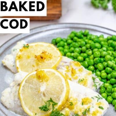 A top-down shot of a serving of lemon butter baked cod on a grey plate. Two fillets of white fish, topped with baked lemon slices and fresh parsley, are arranged next to a generous portion of bright green peas. The plate sits on a marble surface, with a wooden cutting board and blurred green garnish in the background. Yellow text at the top reads "LEMON BUTTER" and black text below it says "BAKED COD". "BAKEITWITHLOVE.COM" is at the bottom center.