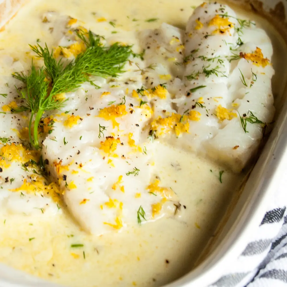 Lemon Butter Baked Cod in a white dish.