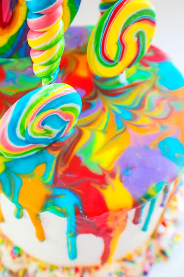 Easy to make and super fun Rainbow Lollipop Drip Cake is fun for all ages and occasions!