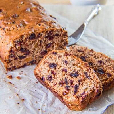 Tasty Irish Barmbrack fruit bread without yeast sliced and served on parchment paper.