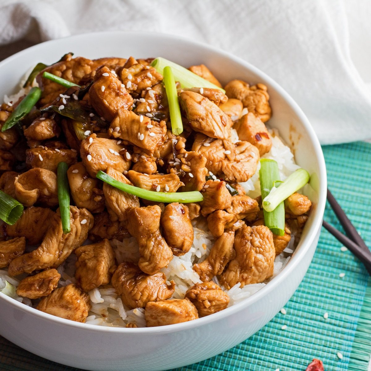 Large square angled overhead image of the instant pot mongolian chicken served in a white bowl.