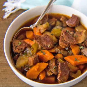 Square image of instant pot beef stew in a white bowl.