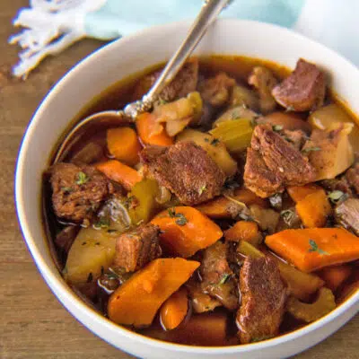 Square image of instant pot beef stew in a white bowl.