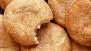 Tasty snickerdoodle cookies are a holiday classic like these tender cookies stacked in a closeup image.