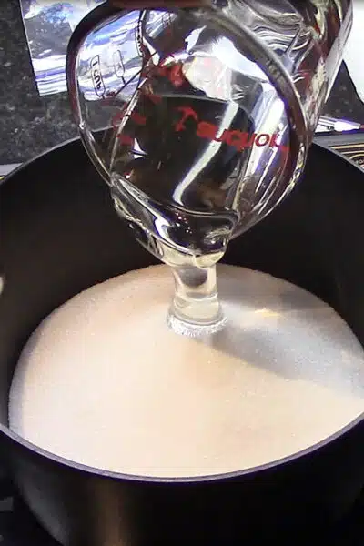 Crack grapes recipe process photo 1 combining syrup ingredients in a saucepan.