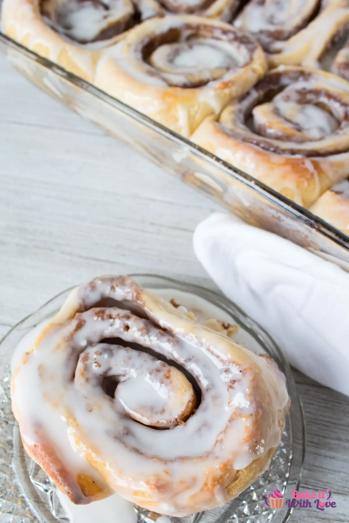 Tall image of cinnamon rolls with icing.