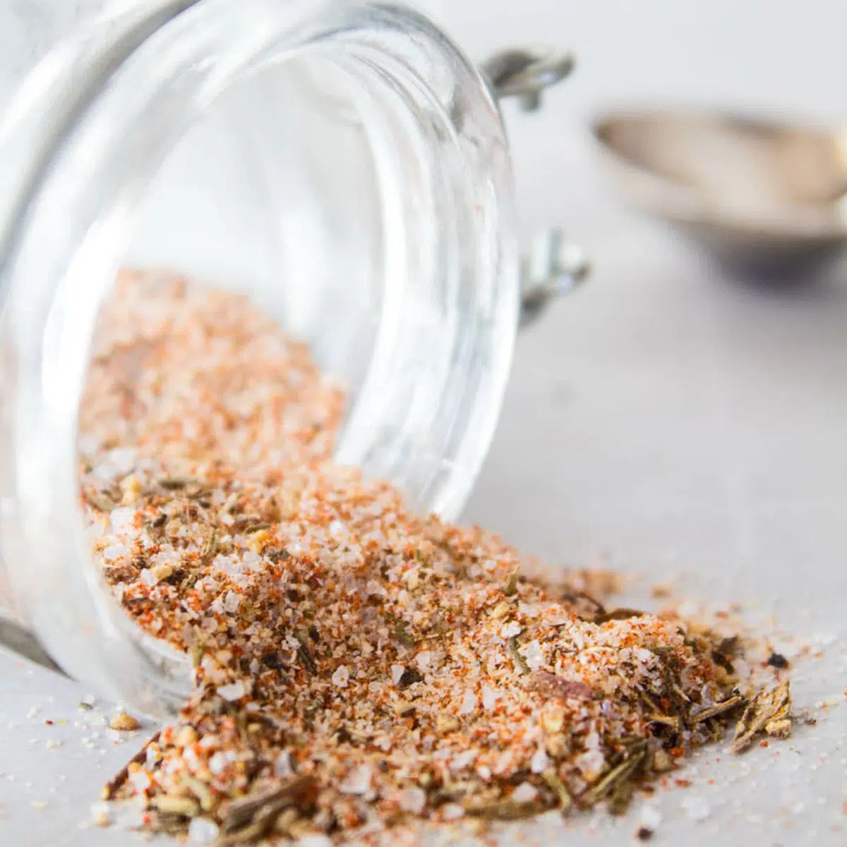 Large photo showing steak seasoning mix spilling out of container.