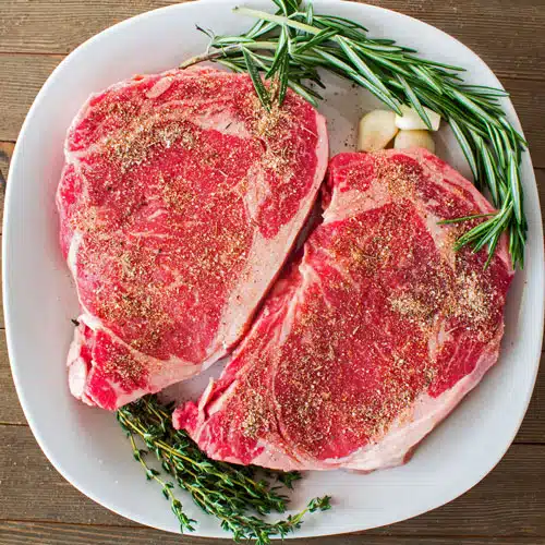 Rib eye steaks at room temperature with my homemade steak seasoning.