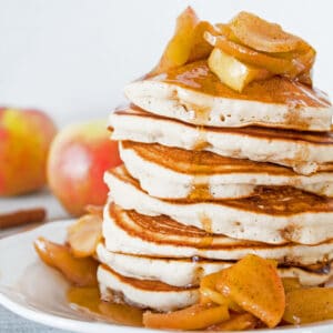 Fluffy, delicious aple cider pancakes feature the delightful flavor of apple cider topped with pan fried cinnamon apples and the drizzled with apple cider syrup!