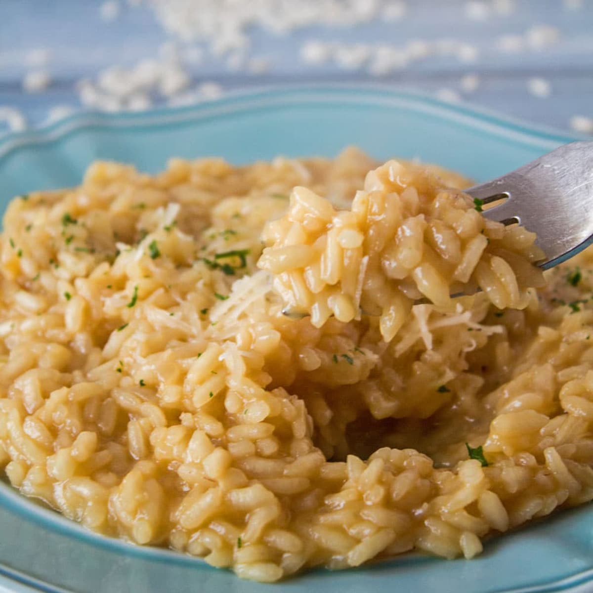 Square image of a plate of Parmesan risotto.