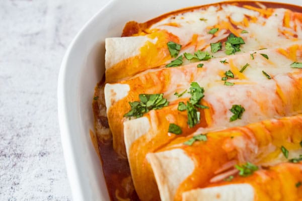 These cheesy chicken enchiladas are an easy to make comfort food and family favorite dinner!