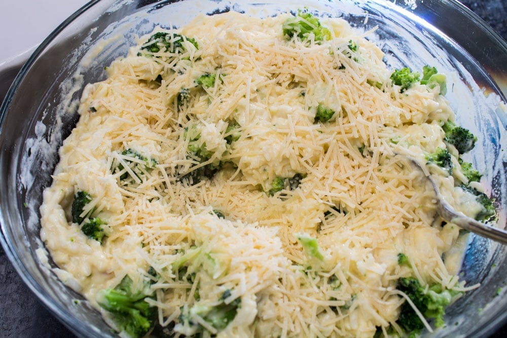 combining chicken divan casserole ingredients - cream of chicken, seasoning, rice, broccoli, Parmigiano cheese