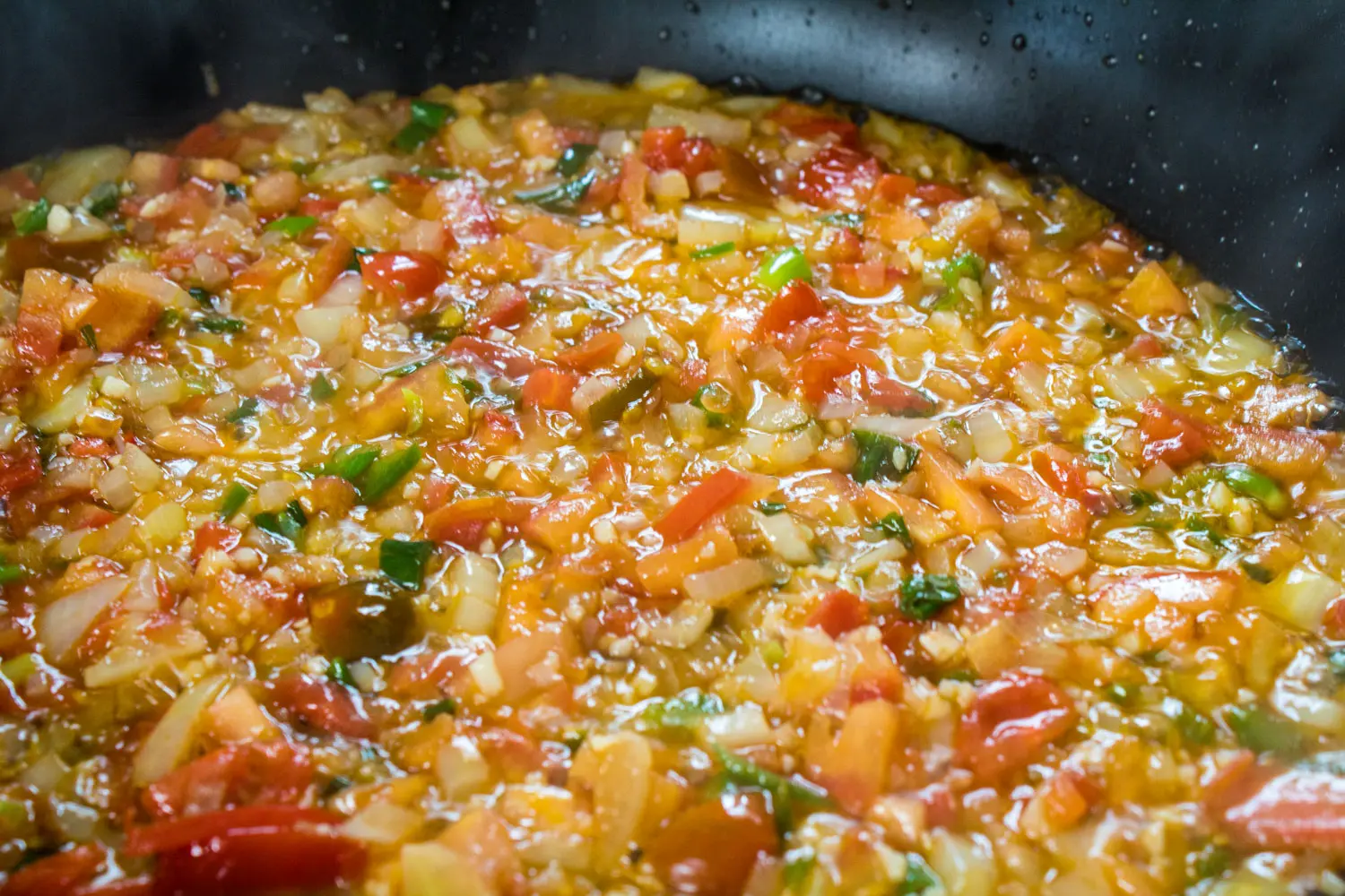 mexican rice simmering with tomatoes, chiles, and cilantro.