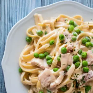Deliciously creamy ham and pea pasta is super easy whether it's made on the stove top or in your crock pot!