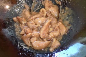 wok fry marinated chicken breast in oil