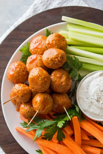 over head image of leftover buffalo turkey meatballs on a tray with carrots, celery, and ranch dressing