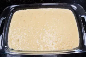 pineapple sunshine cake mixed and poured into baking dish ready to bake