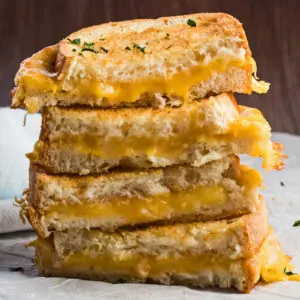 wide straight on view of the air fryer grilled cheese sandwiches stacked.