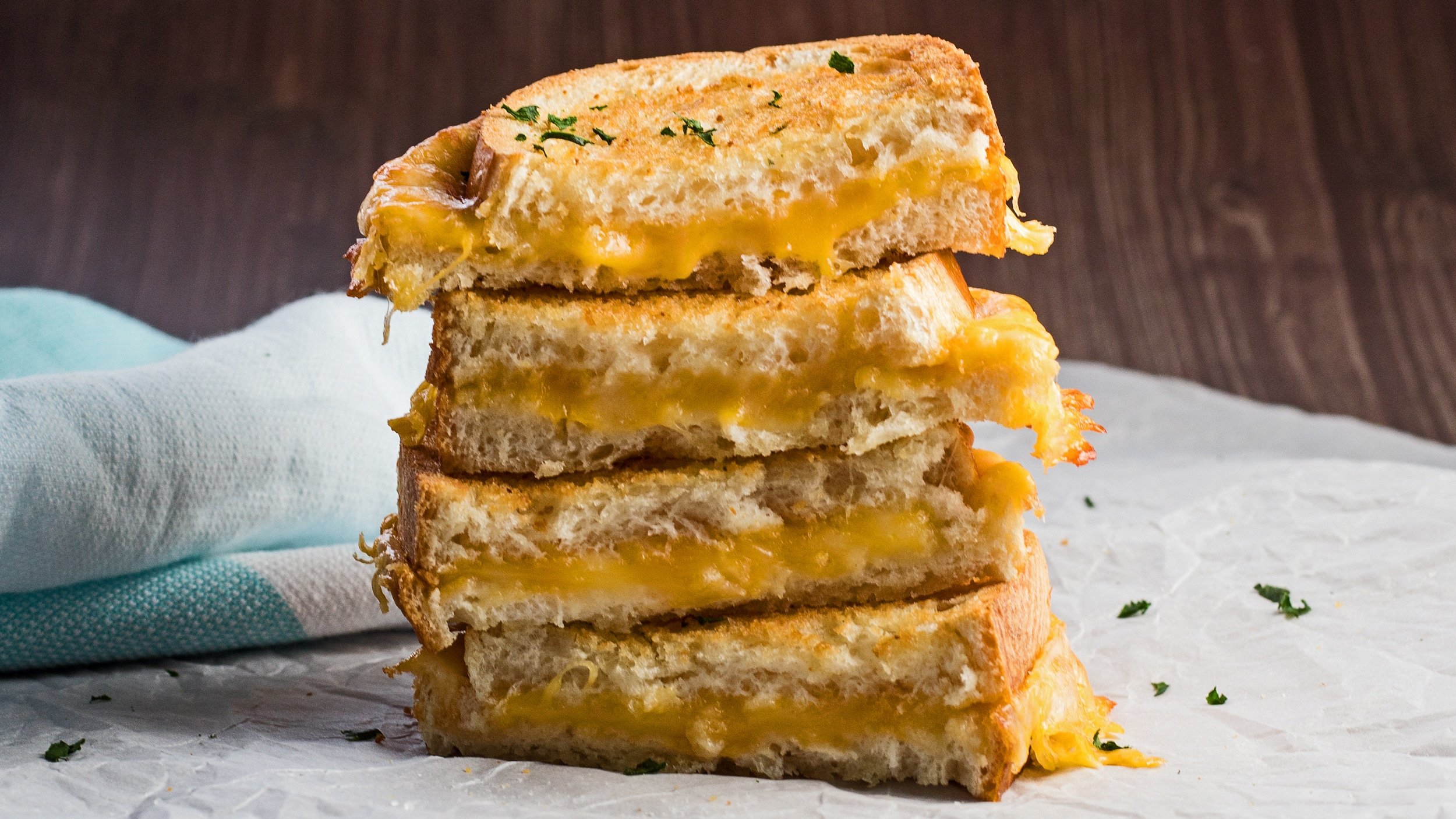 wide straight on view of the air fryer grilled cheese sandwiches stacked.