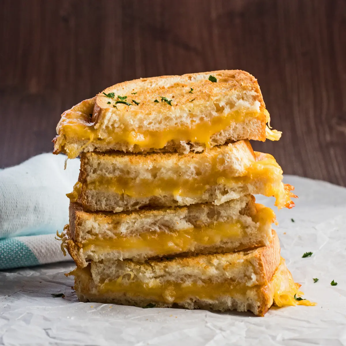large square straight on view of the air fryer grilled cheese sandwiches stacked.