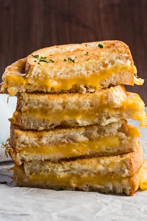 tall closeup straight on view of the air fryer grilled cheese sandwiches stacked.