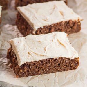 large square image of the frosted and sliced chocolate banana cake