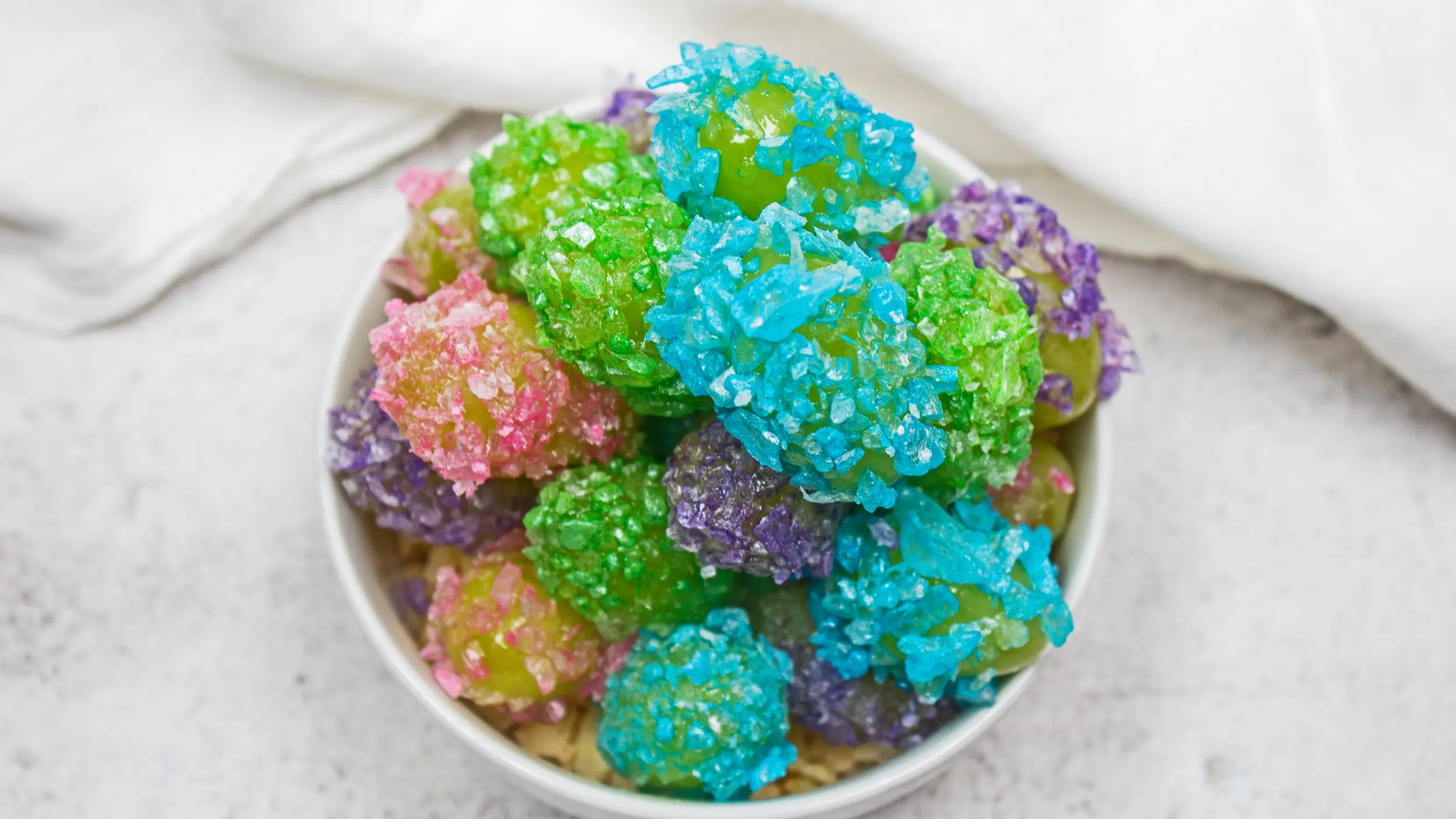 jolly rancher hard candy coated crack grapes in rainbow pastel colors.