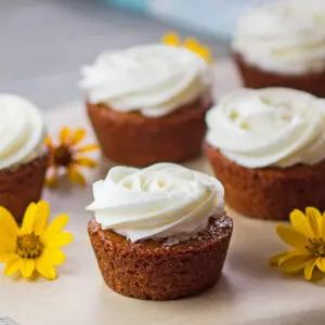 Large square image of delicious honey cakes drizzled with honey and topped with frosting.
