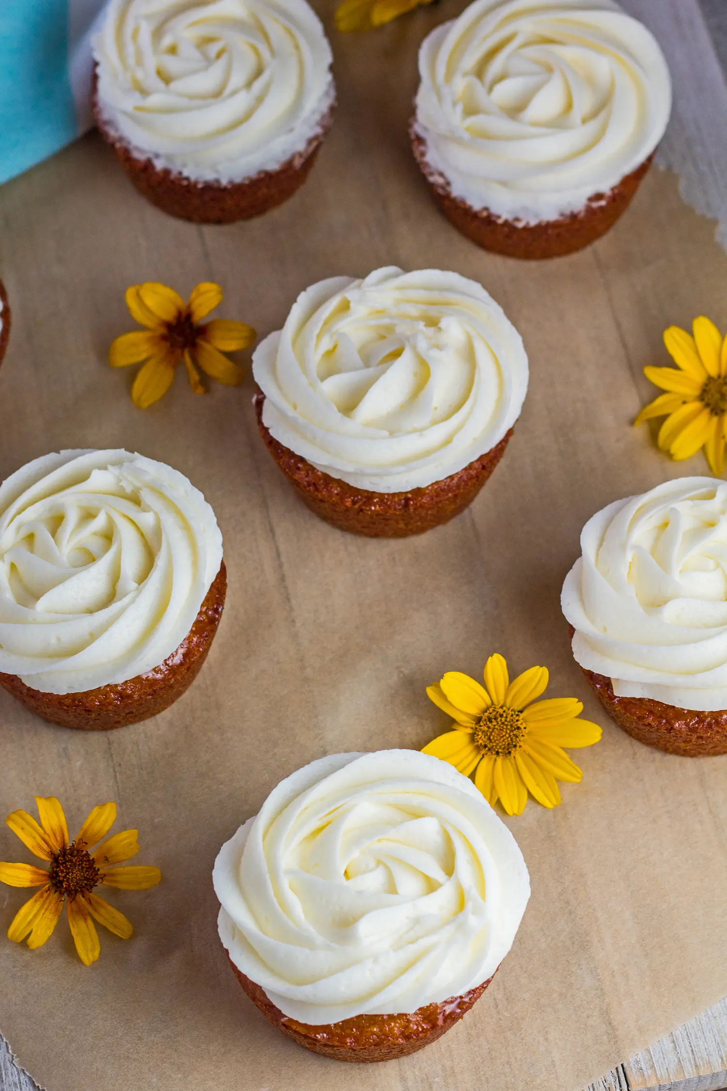 Delicious honey cakes topped with orange frosting from an angled overhead view.
