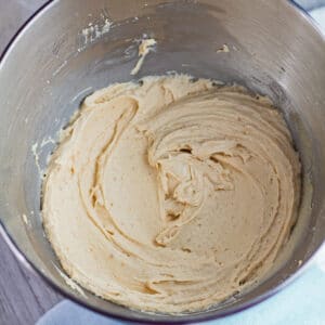 large square overhead of peanut butter cream cheese frosting in the stand mixer bowl