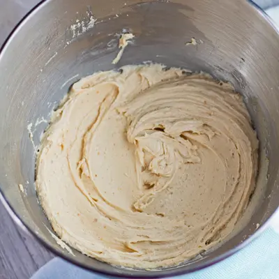 small square overhead of peanut butter cream cheese frosting in the stand mixer bowl