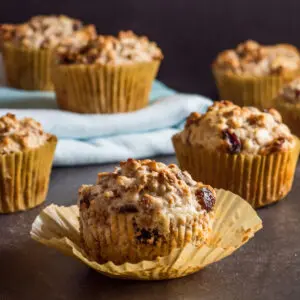 Large square image of raising bran muffins on dark background.
