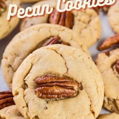 pin with overhead image of peanut butter pecan cookies on white background with text overlay.