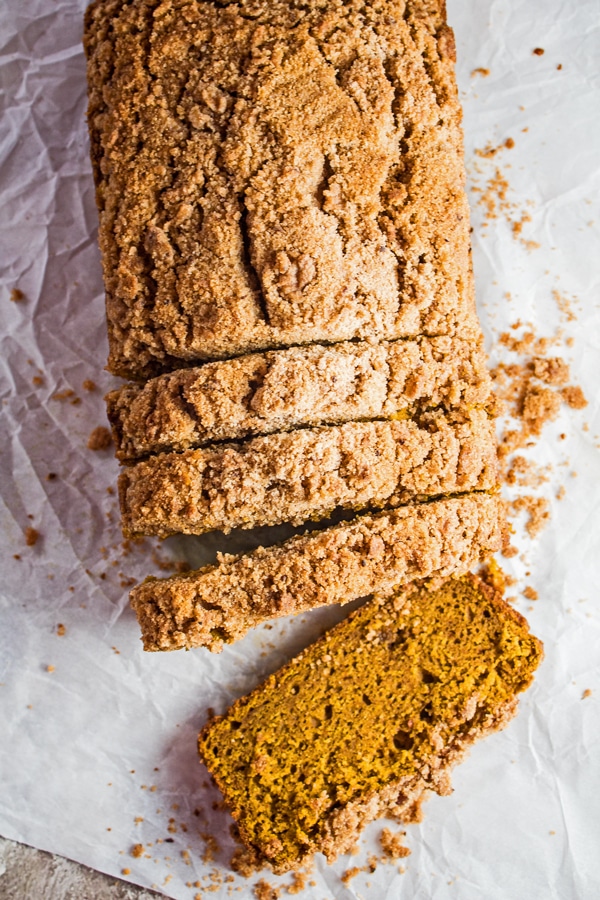 tall overhead of the sliced pumpkin streusel bread loaf and slices.
