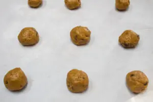 chilled dough formed into balls and on baking sheet.