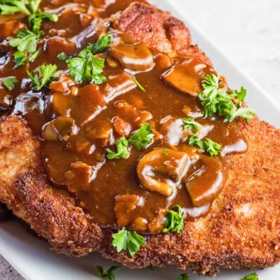 wide angled overhead image of jagerschnitzel served on white plate.