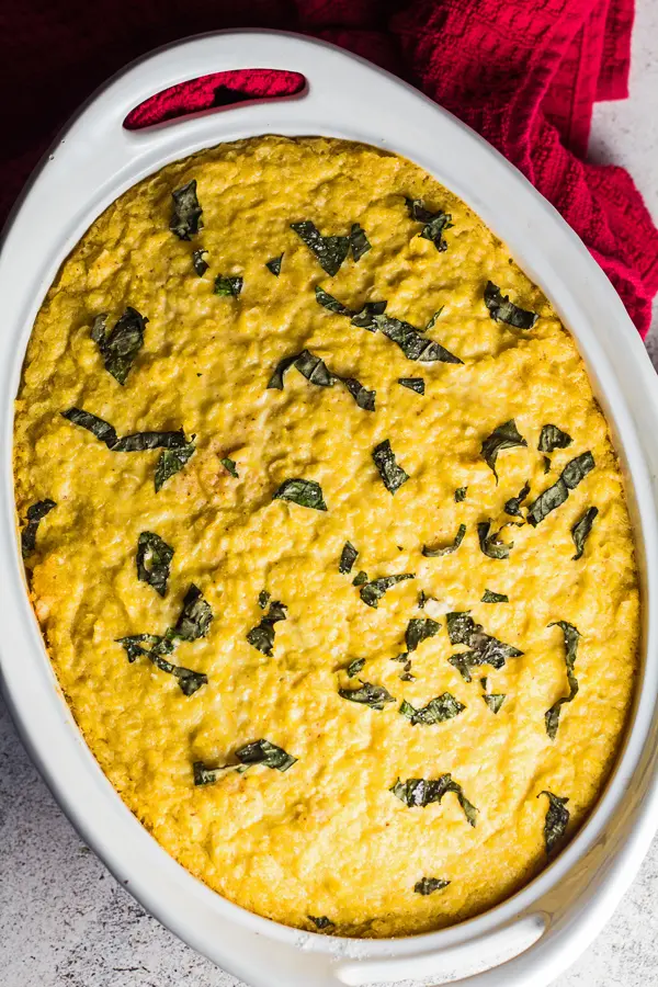 tall overhead image of pastel de choclo as baked in white casserole dish.