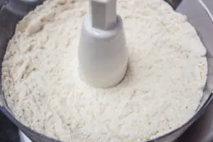 butter cut into the dry ingredients after processing in food processor.